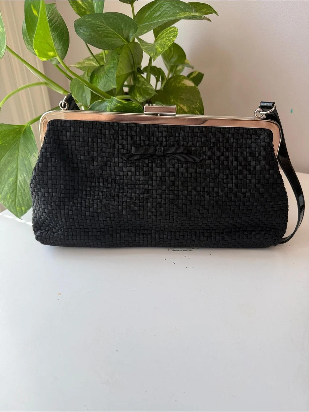 The SAK Black Woven Frame Clutch/Handbag with Bow Accent